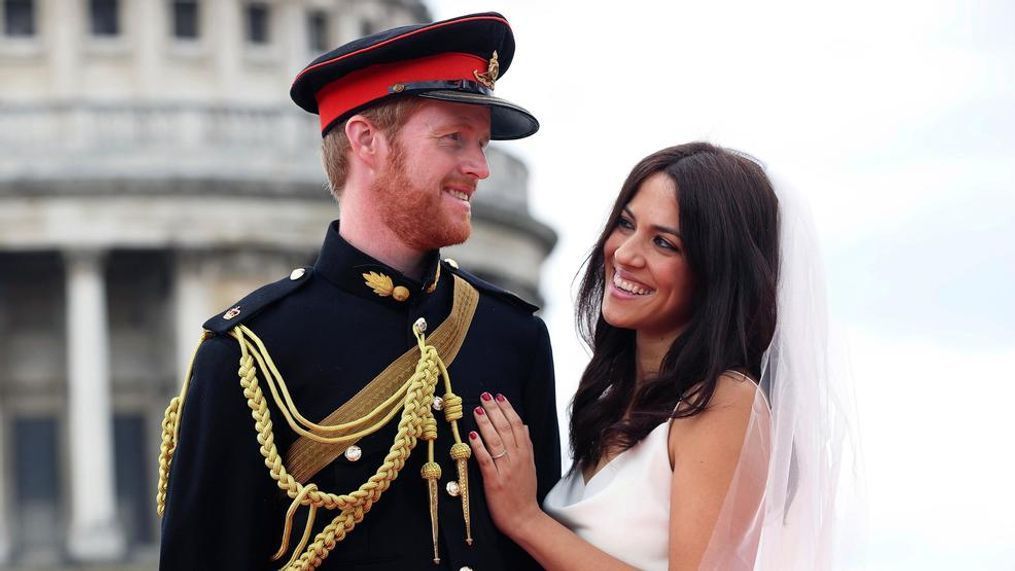 In this handout image issued by PinPep.com and taken on Sunday May 13, 2018, Prince Harry and Meghan Markle lookalikes Rhys Whittock from Britain and Inmaculada Santisteban Serrano from Spain, pose for a photograph in London. (Joe Pepler/PinPep via AP)