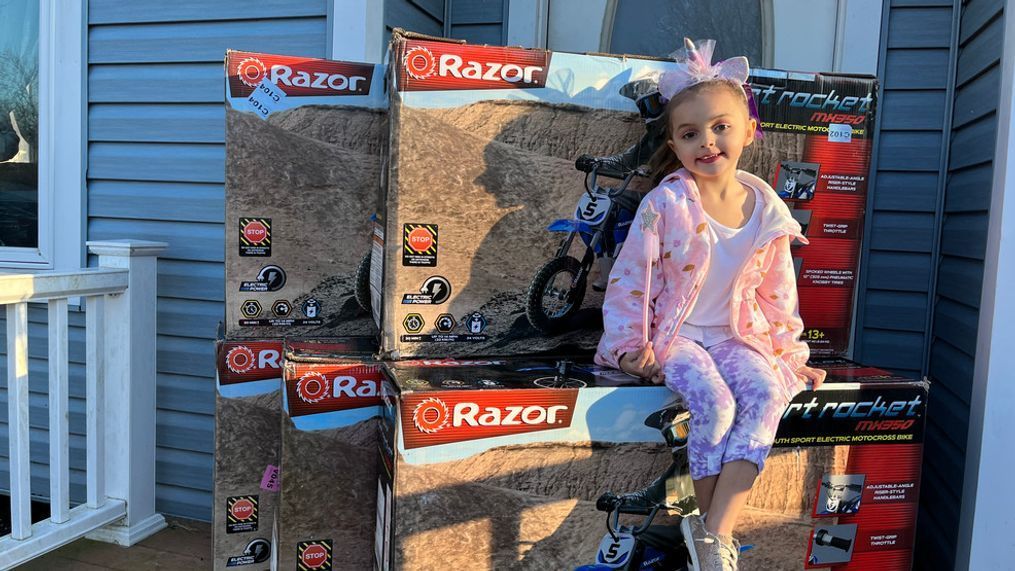 Lila sits with some of the motorcycles she ordered on her mom's Amazon account. (WJAR){&nbsp;}