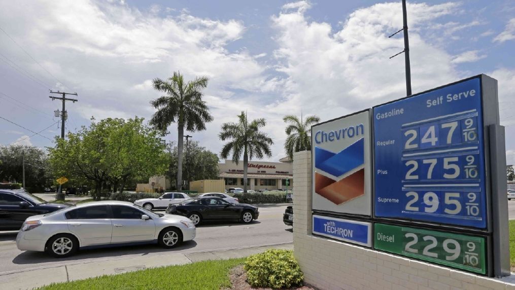 Motorists pass by a Chevron gas station in Miami. A new survey from AAA finds that saving a few pennies on non-brand gasoline can eventually hurt your car’s fuel economy. (AP Photo/Alan Diaz)