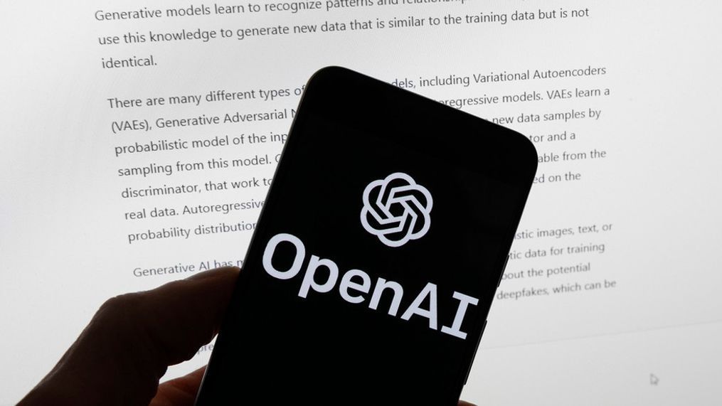 FILE - The OpenAI logo is seen on a mobile phone in front of a computer screen displaying output from ChatGPT, March 21, 2023, in Boston. (AP Photo/Michael Dwyer, File)