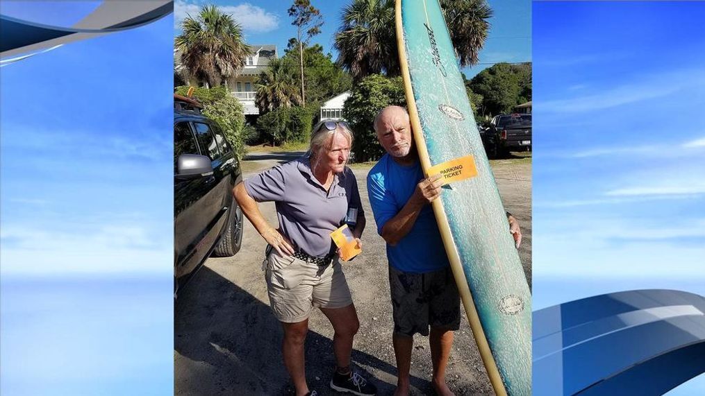 "Surfing in a Hurricane" singer Jimmy Buffett on Folly Beach, S.C., Tuesday, Sept. 11, 2018, posing for a funny photo with a Palmetto Parking employee. (Courtesy Becca Savage Lovett)