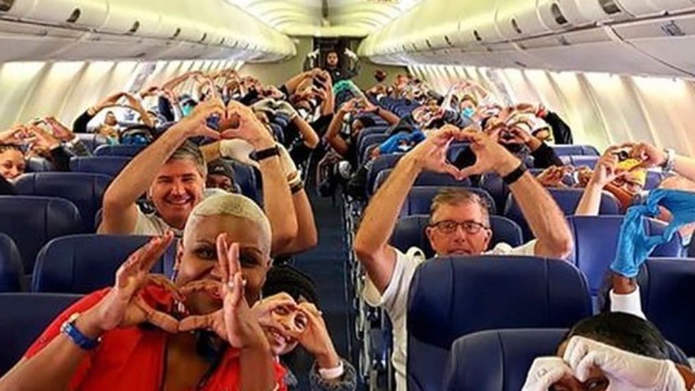 This Friday, March 27, 2020, photo provided by Southwest Airlines employee Dayartra Etheridge shows health care workers, other passengers and flight crew aboard a Southwest flight from Atlanta to New York's LaGuardia Airport. (Dayartra Etheridge via AP)