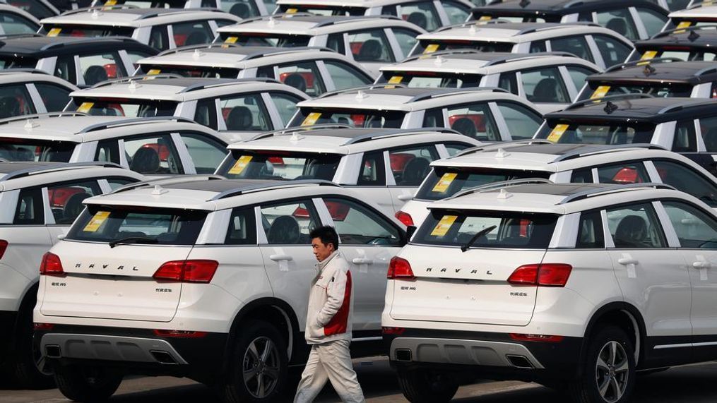 In this Feb. 19, 2017, file photo, a worker walks past Haval SUV models parked outside the Great Wall Motors assembly plant in Baoding in north China's Hebei province. Chinese SUV maker Great Wall Motors is considering making a bid to acquire Fiat Chrysler's Jeep unit, two employees of the Chinese company said Monday, Aug. 21, 2017 in an ambitious new move for the country's fast-growing domestic auto brands. Great Wall has yet to make a formal announcement of its interest in Jeep but a possible acquisition would be in line with chairman Wang Jianjun's goal, announced in February, of becoming the top specialty SUV producer by 2020. (AP Photo/Andy Wong, File)