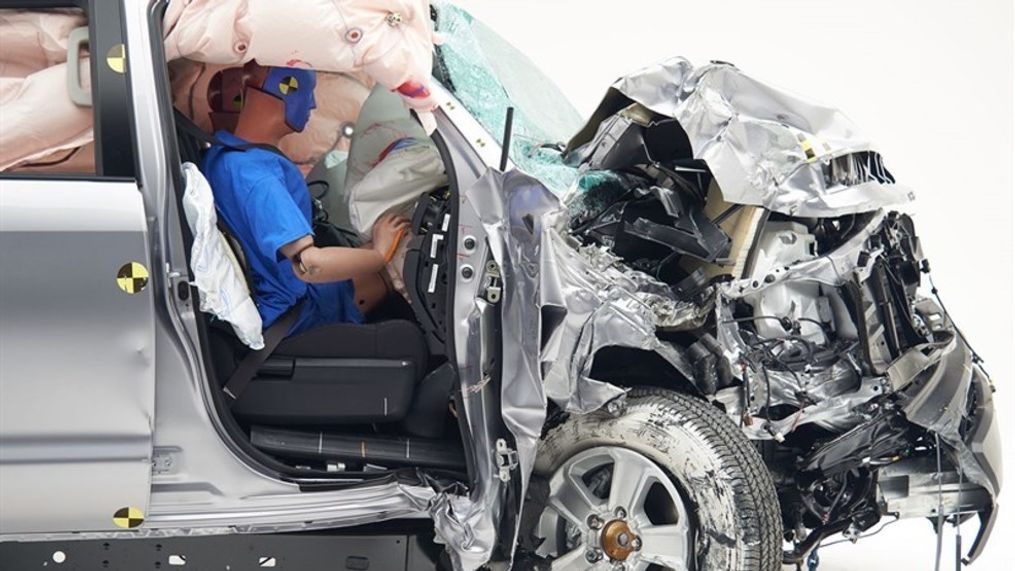 Insurance Institute for Highway Safety small overlap front passenger side crash test photo:{&nbsp;}The dummy's position in relation to the door frame and dashboard after the crash test indicates that the passenger's survival space was not maintained well. (Image courtesy of the Insurance Institute for Highway Safety){p}{/p}