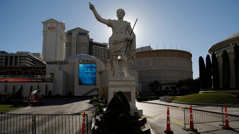 Gates block an entrance to Caesars Palace hotel and casino along the Las Vegas Strip devoid of the usual crowds during the coronavirus pandemic, Tuesday, May 26, 2020, in Las Vegas. (AP Photo/John Locher)