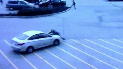 Image for story: Video: Home Depot shoplifter drives off with worker on his car