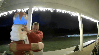 Image for story: VIDEO: Amazon driver in Tennessee secures Christmas decorations knocked down by wind