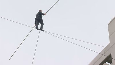 Image for story: Daredevil walks across high wire over National Harbor 