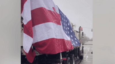 Image for story: Vehicles block streets in Michigan demanding end to Governor's "stay-at-home" order