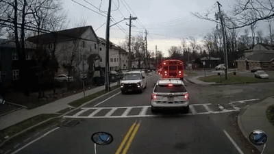 Image for story: Driver caught on camera passing school bus with flashing lights