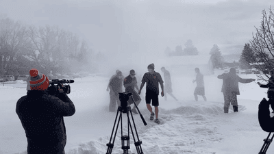 Image for story: Police officers create own version of polar bear plunge with firehose and snow angels