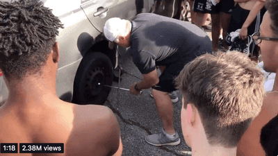 Image for story: High school football coach teaches his players how to change a tire