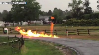 Image for story: Road sign catches fire after lightning strikes nearby gas line