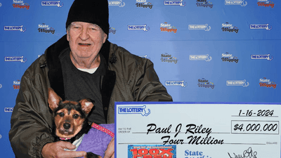 Image for story: Lottery winner claims $4 million prize with dog, plans on donating to animal rescue