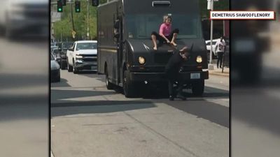 Image for story: Caught on camera: Woman on top of delivery truck hits man with windshield wiper