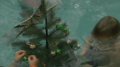 Image for story: Underwater Christmas tree decorating teaches kids a valuable lesson