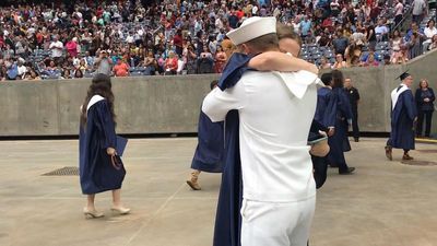 Image for story: Navy officer surprises sister at high school graduation