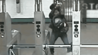 Image for story: Woman with hammer smashes 'tap-and-go' screens at Harlem subway station