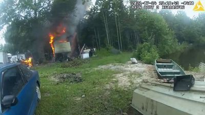 Image for story:  VIDEO: Cops risk lives to save 2 trapped dogs near burning trailer