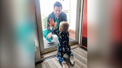 Image for story: The story behind a viral photo of an Arkansas doctor and his son