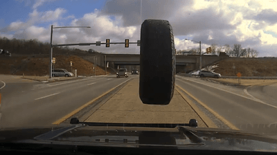 Image for story: VIDEO: Out-of-control tire barrels down road, crashes into police cruiser