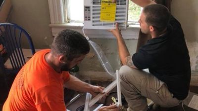 Image for story: Inspiring: Business installs A/C unit for elderly woman living with a broken one