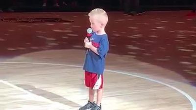 Image for story: Little boy sings The National Anthem in front of basketball fans