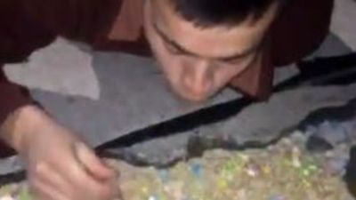 Image for story: Michigan man eats cereal from a pothole on the road