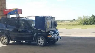 Image for story: Texas police issue warning to driver with washing machine on hood of SUV