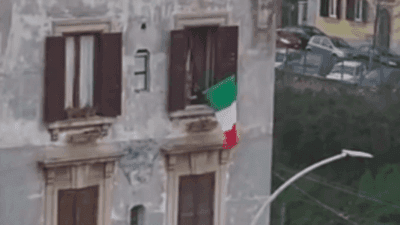 Image for story: Quarantined Italians play music from balconies to raise spirits