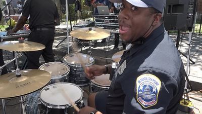 Image for story: Meet the DC police officers who bring funk and go-go music to city streets each summer