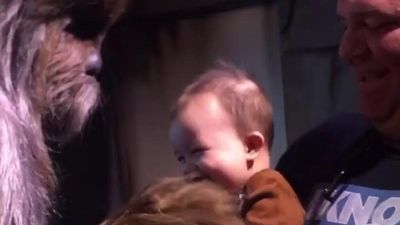 Image for story: Baby giggles with Chewbacca at Disney World