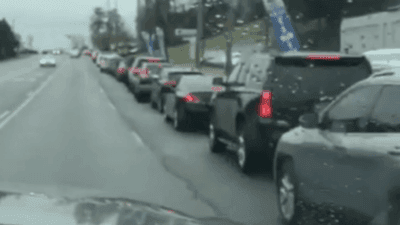 Image for story: Vehicles line up for drive-thru COVID-19 testing in Birmingham, Alabama