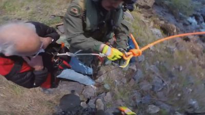 Image for story: VIDEO: Special helicopter rescues lost person in California woods