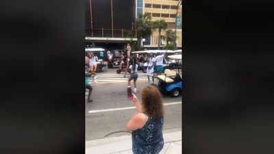 Image for story: Large crowd in South Carolina ignores social distancing, dances in the middle of street