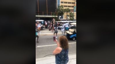 Image for story: Large crowd in South Carolina ignores social distancing, dances in the middle of street