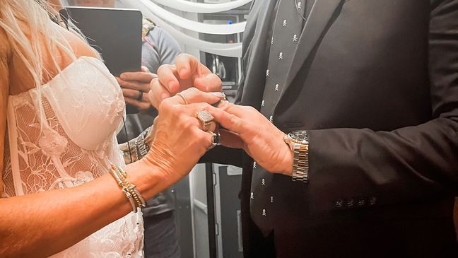 Pam Patterson and Jeremy Saldas hold hands and exchange rings during the impromptu ceremony. (Photo: Kaitlyn Manzer)