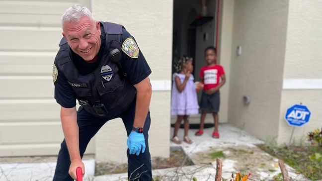 Police officers helped a family trapped in their home after Hurricane Ian, Sept.  29,  2022.  (Port St. Lucie Police Dept.)