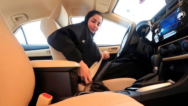 This image released by the Saudi Information Ministry, shows a Saudi woman buckling her seat belt before doing a driving test at the General Department of Traffic in the Saudi capital of Riyadh, Monday, June 4, 2018. (Photos by Saudi Information Ministry via AP)