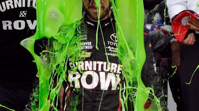 Martin Truex Jr. celebrates with his crew in Victory Lane after winning a NASCAR Cup Monster Energy Series auto race at Chicagoland Speedway in Joliet, Ill., Sunday, Sept. 17, 2017. (AP Photo/Nam Y. Huh)