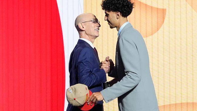 Zaccharie Risacher, right, greets NBA commissioner Adam Silver after being selected as the first overall pick by the Atlanta Hawks in the first round of the NBA basketball draft, Wednesday, June 26, 2024, in New York. (AP Photo/Julia Nikhinson)