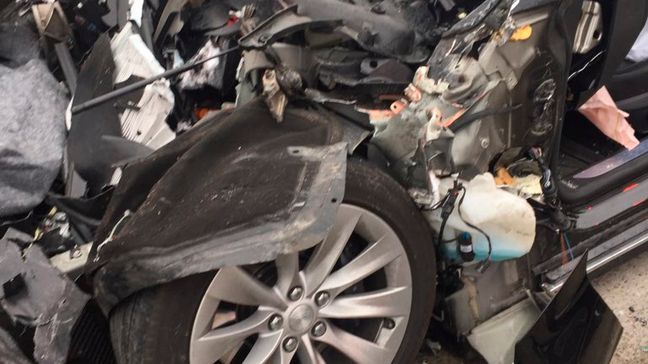 In this Friday, May 11, 2018, photo released by the South Jordan Police Department shows a traffic collision involving a Tesla Model S sedan with a Fire Department mechanic truck stopped at a red light in South Jordan, Utah. Witnesses indicated the Tesla Model S did not brake prior to impact. Police Sgt. Samuel Winkler said the car's air bags were activated and that the Tesla's 28-year-old driver suffered a broken right ankle, while the driver of the mechanic truck didn't require treatment. Police in a Salt Lake City suburb say it's not immediately known whether a Tesla Model S sedan's semi-autonomous Autopilot driving system was in use when it rear-ended a truck apparently without braking before impact at approximately 60 mph. (South Jordan Police Department via AP)