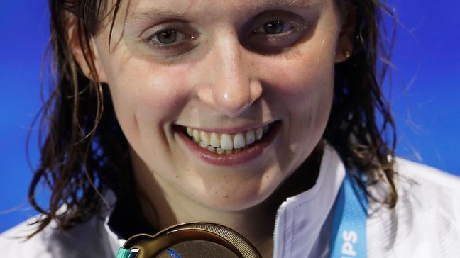 United States' gold medal winner Katie Ledecky shows off her medal after the women's 800-meter freestyle final during the swimming competitions of the World Aquatics Championships in Budapest, Hungary, Saturday, July 29, 2017. (AP Photo/Petr David Josek)