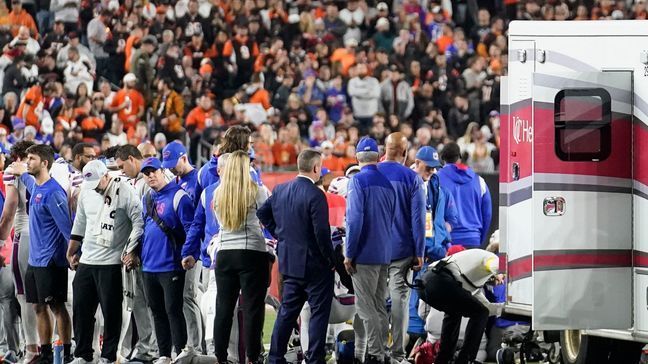 FILE - Buffalo Bills players and staff pray for Bills safety Damar Hamlin during the first half of an NFL football game against the Cincinnati Bengals, Jan. 2, 2023, in Cincinnati. The Bills training staff will receive the Pat Tillman Award for Service at The ESPYS on July 12, 2023, for helping save the life of Hamlin. (AP Photo/Joshua A. Bickel, File)