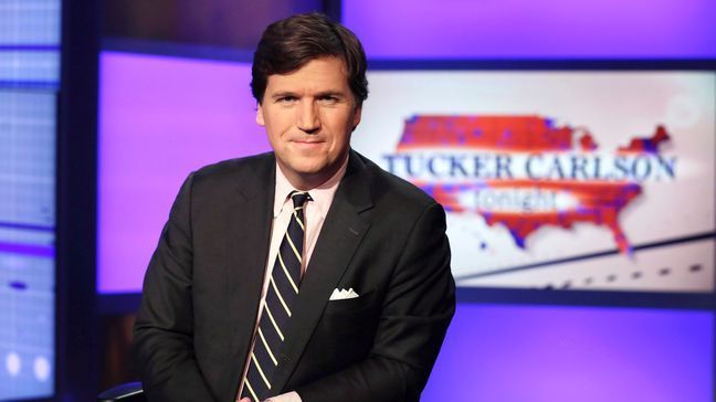 FILE - Tucker Carlson, host of "Tucker Carlson Tonight," poses for photos in a Fox News Channel studio on March 2, 2017, in New York.{&nbsp;} (AP Photo/Richard Drew, File)