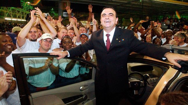 In this May 27, 2003, file photograph, Nissan's Chairman Carlos Ghosn, foreground, is surrounded by celebrating employees of Mississippi's first auto manufacturing facility in Canton, Miss.  The United Auto Workers faces a strong anti-union campaign from Nissan Motor Co. as it tries to gain a foothold in the union-averse South by organizing workers at the Japanese automaker’s Mississippi plant. As many as 4,000 workers will vote Aug. 3-Aug. 4, 2017  the vehicle assembly plant in Canton, just north of Jackson.(AP Photo/Rogelio V. Solis, File)