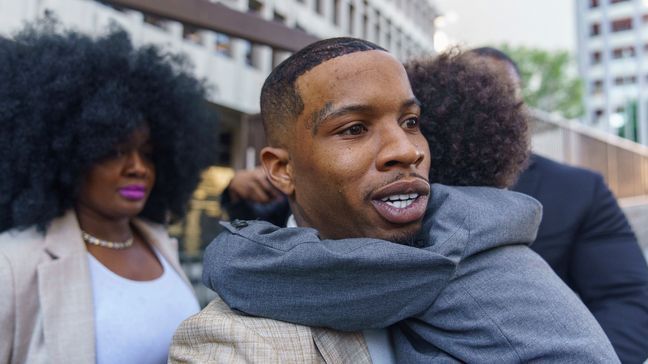 FILE - Rapper Tory Lanez, 30, walks out of the courthouse while holding his 5-year-old son Kai'Lon, Tuesday, Dec. 13, 2022, in Los Angeles.{&nbsp;} (AP Photo/Damian Dovarganes)