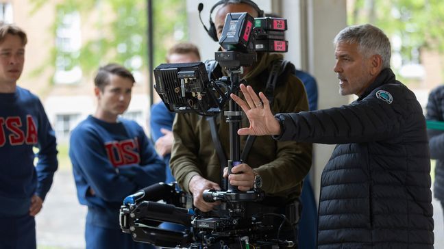 This image released by MGM Pictures shows director George Clooney, right, on the set of "The Boys in the Boat." (Laurie Sparham/Metro-Goldwyn-Mayer Pictures via AP)