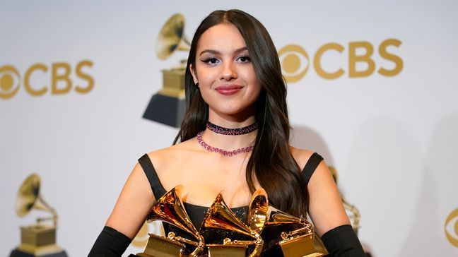 Olivia Rodrigo, winner of the awards for best pop vocal album for "Sour," best new artist and best pop solo performance for "drivers license," poses in the press room at the 64th Annual Grammy Awards at the MGM Grand Garden Arena on Sunday, April 3, 2022, in Las Vegas. (AP Photo/John Locher)