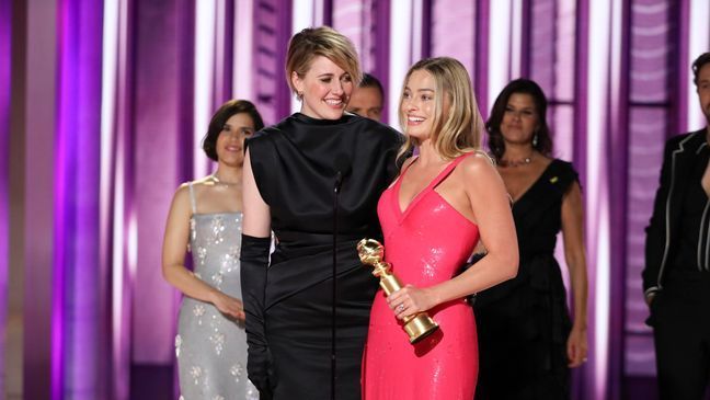 FILE - This image released by CBS shows director and co-writer Greta Gerwig, left, and actor Margot Robbie accepting the award for best cinematic and box office achievement for the film "Barbie" during the 81st Annual Golden Globe Awards in Beverly Hills, Calif., on Sunday, Jan. 7, 2024. (Sonja Flemming/CBS via AP)